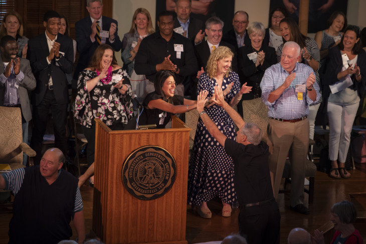 Alumni on stage celebrating at Alumni Reunion Weekend 