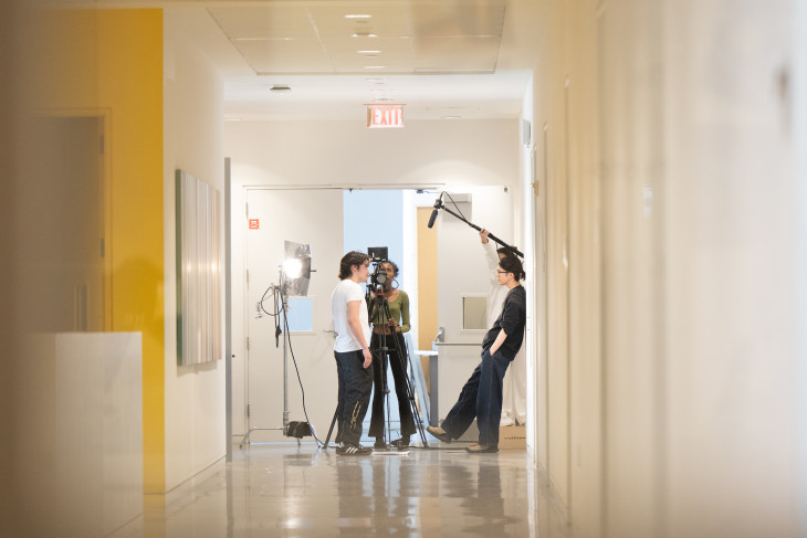 Students in a hallway with film equipment