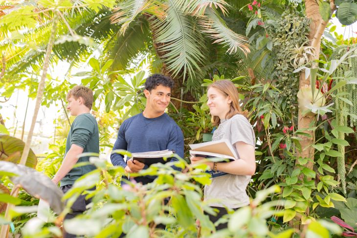 Two students in greenhouse