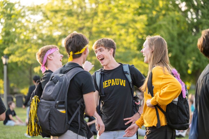 Group of students talking and laughing outside