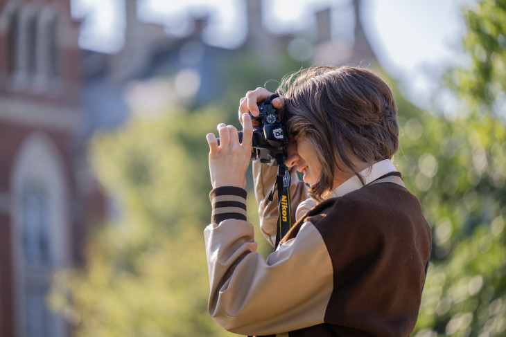 Student looking into a camera taking a photo