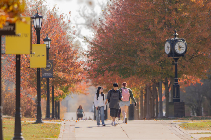 Students walk to class on campus sidewalks