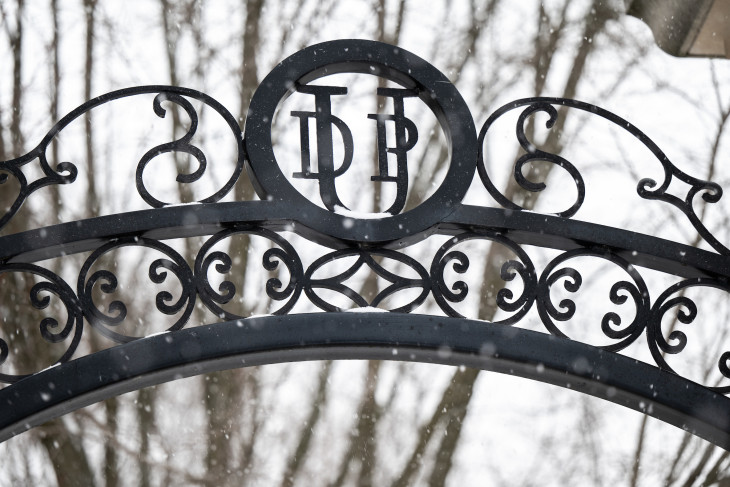 DePauw gate with DPU insignia and snow falling 