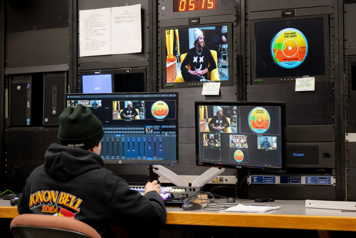 Student editing footage on numerous computers