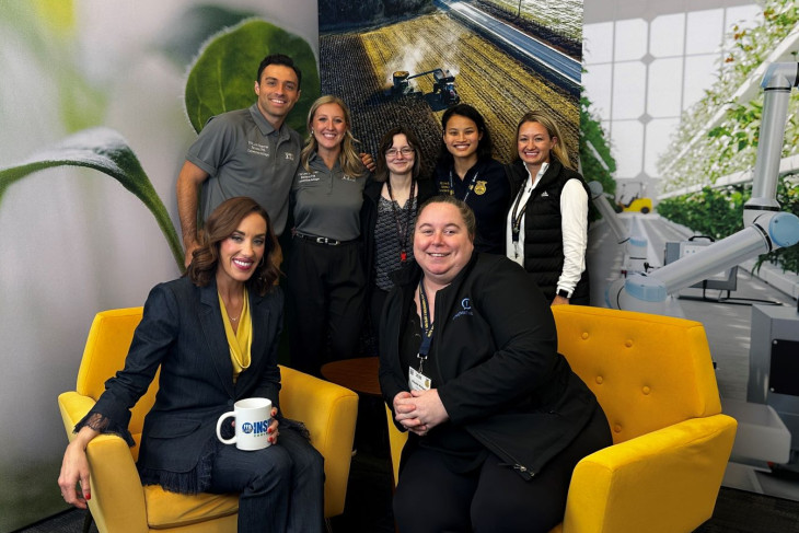 Group posed smiling in newsroom