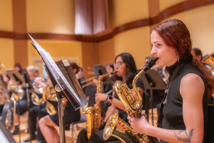 Students playing brass instruments in orchestra practice