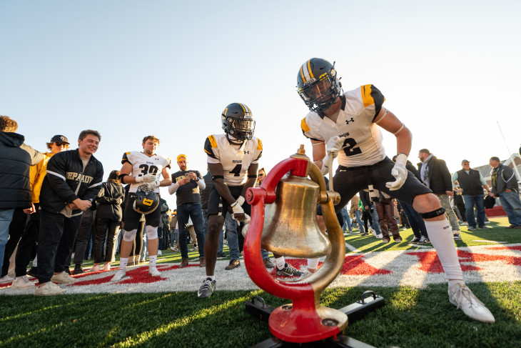 DePauw players celebrate with Monon Bell