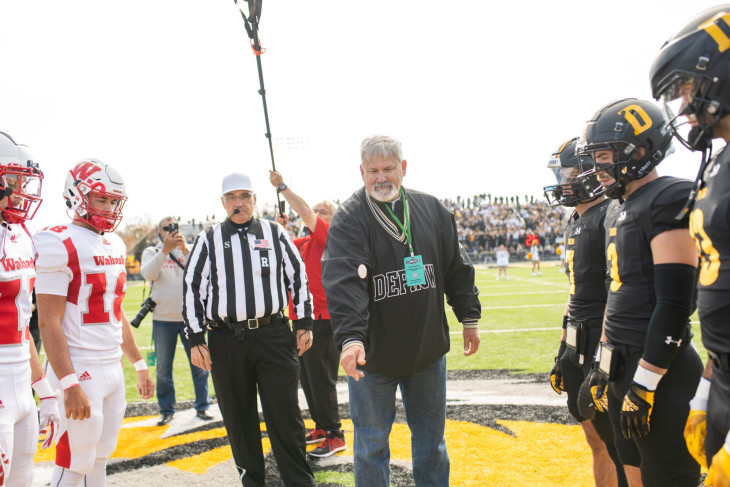 Tony Robertson flips coin before game