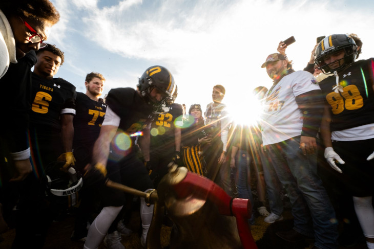 DePauw players celebrate with Monon Bell