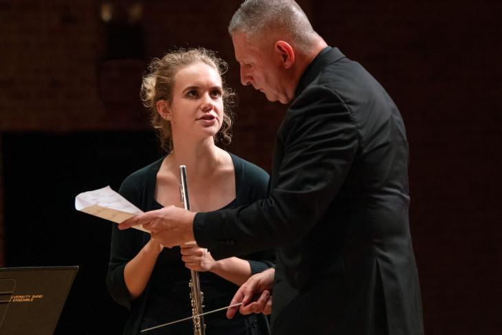 Conductor sharing notes with student musician