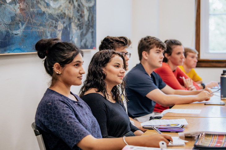 Line of students sitting at a table in class