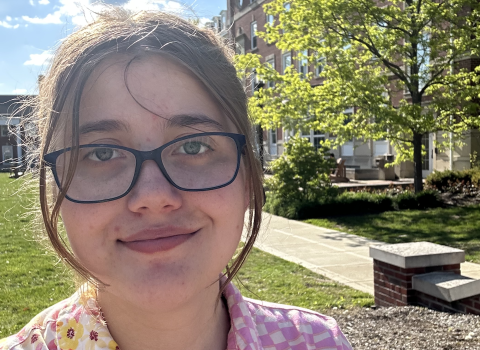 Anne stands outside on DePauw's campus on a sunny day