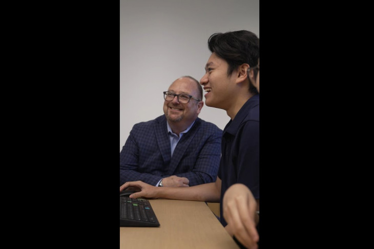 Video still of professor and student