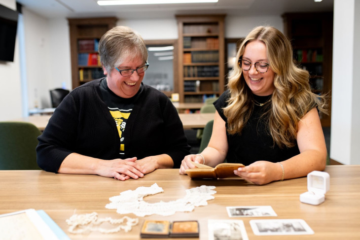 Caroline Gilson and Laney Collier study a diary