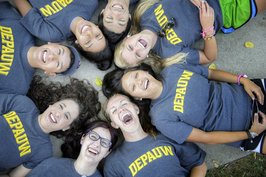 Students laughing in circle with DePauw shirts