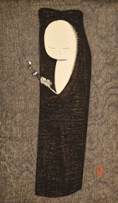 A girl bundled in black holding a flower