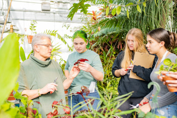 Students and teacher in greenhouse